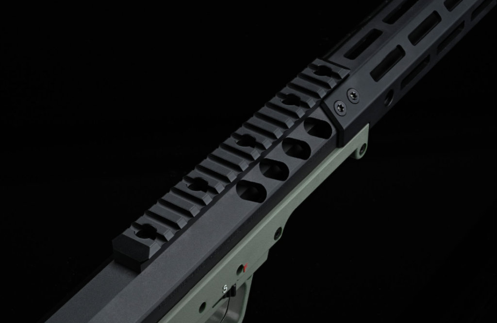 "Detailed shot of the Picatinny rail and its securing bolts, essential for custom attachments, set on the barrel's protective tube.
